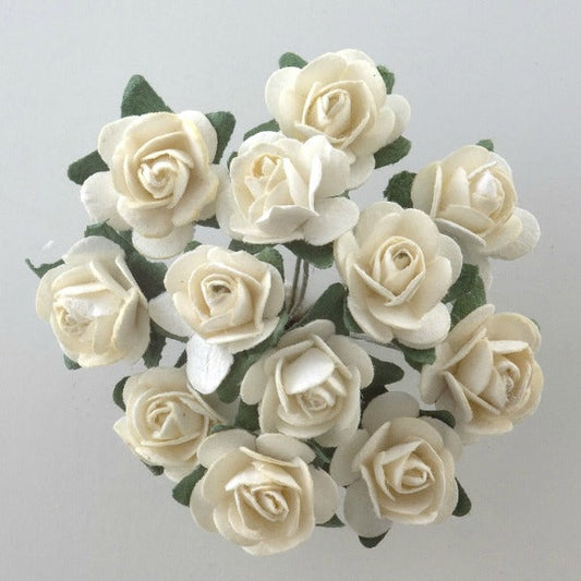 The Cream Paper Tea Roses Bunch of 12 by Perfect Tables features a bouquet of small, cream-colored paper tea roses arranged in a circular pattern against a light background. The roses are interspersed with green paper leaves, adding a touch of natural contrast to this perfect addition for craft projects or gift wrapping.